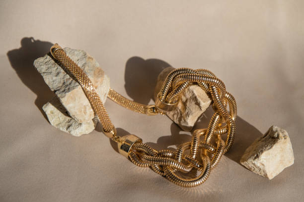 istock Still life with golden necklace over beige background. Minimalistic abstract composition. 1491055904