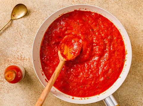Homemade tomato sauce on a spoon for pasta or spaghetti or pizza
