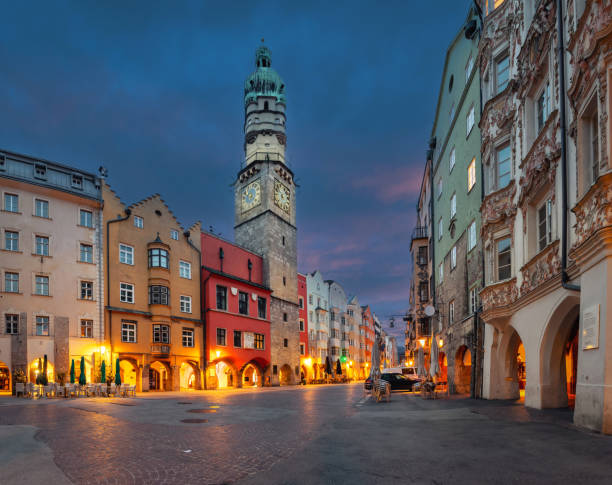 Innsbruck, Austria - view of historic Stadtturm tower with clock at dusk