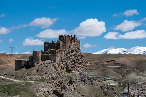 View of Hoşap Castle in the countryside of Van city, Türkiye. The medieval castle is located on a steep slope. Shot with a full frame camera on a cloudy day in daylight.