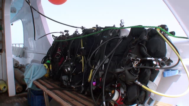 Diving equipment BCD for diving safari on bench of yacht.