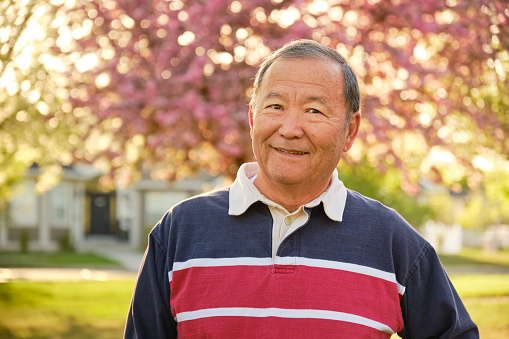 An outdoor portrait of a senior aged man.