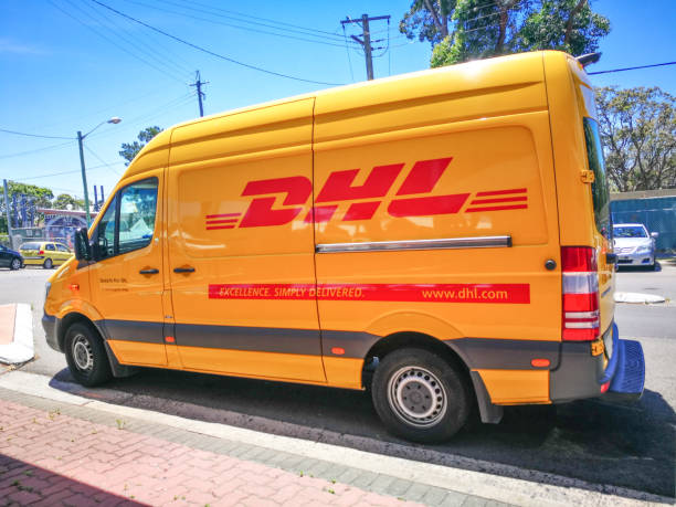 dhl express van courier, parcel and express mail services. - driving delivery van global business dhl imagens e fotografias de stock