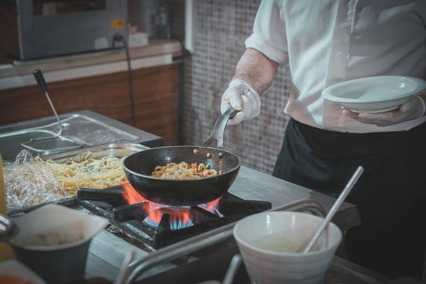 istock Young chef man preparing the pasta in a professional kitchen 1491066204