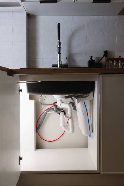 istock House water filtration system to drinkable condition, reverse osmosis. Installation or replacement filter cartridges of foamed polypropylene, granular, briquettes carbon under kitchen sink with lights 1491066550