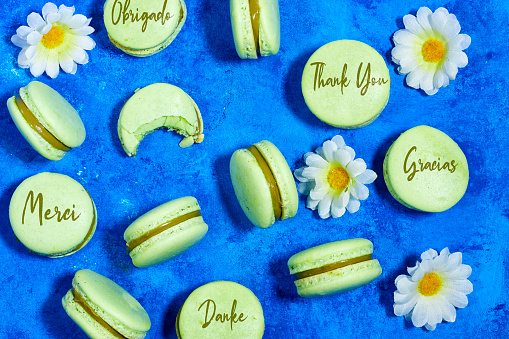 Thank you in different languages written on French pistachio macarons