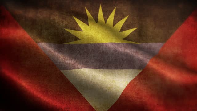 Closeup of grunge Antigua and Barbuda waving flag loopable stock video