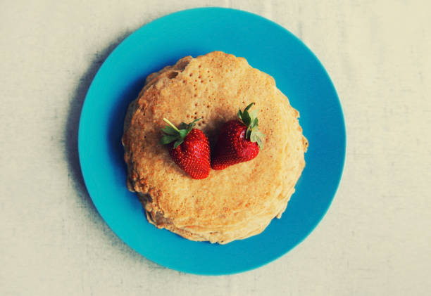 Cooking, stack of pancakes with strawberries on blue plate
