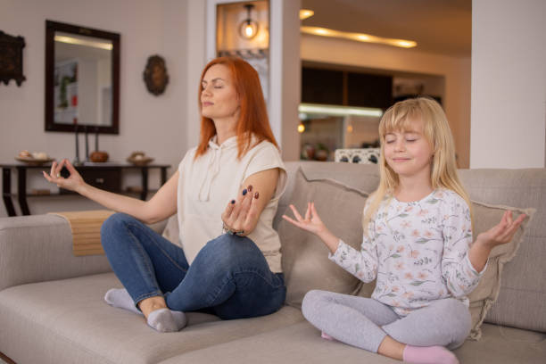 istock Mother is meditating with her little daughter 1491080703