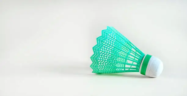 Photo of Green badminton shuttlecock on a white background. Game concept.