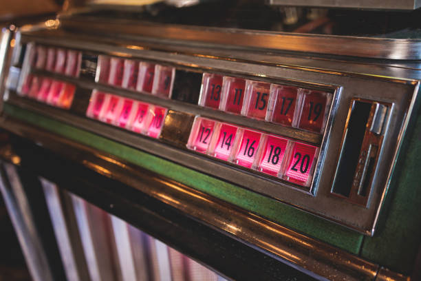 istock Vintage American music jukebox with illuminated buttons, process of choosing song composition, retro old-fashioned juke-box with vinyl discs musical box machine in cafe diner restaurant 1491082264