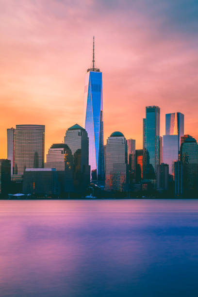 The Freedom Tower and NYC Skyline at Sunrise The Freedom Tower and lower Manhattan framed by trees skyscraper office building built structure new york city stock pictures, royalty-free photos & images