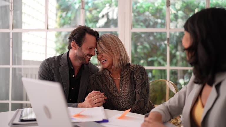 Financial advisor talking to a couple in a house