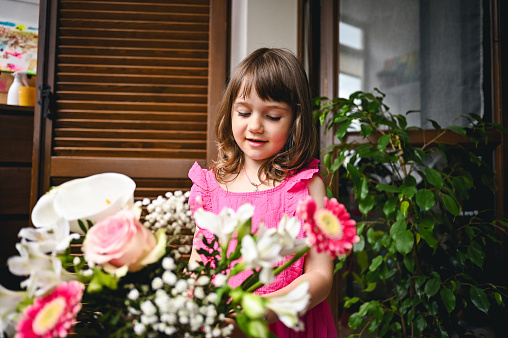 Daughter giving flowers to her mother
