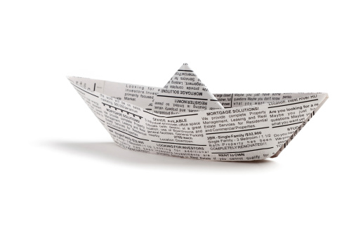 Newspaper boat, business concept.