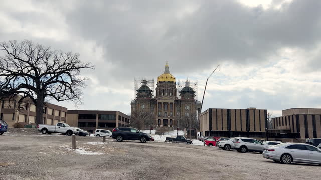 Side Trucking Shot of Driving Past a Parking Lot Next to the Iowa State Capitol on a Cold Day in Winter