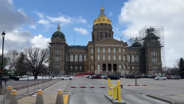 Side Trucking Shot of Driving Past the Iowa State Capitol and a Parking Lot in Des Moines on a Snowy Day