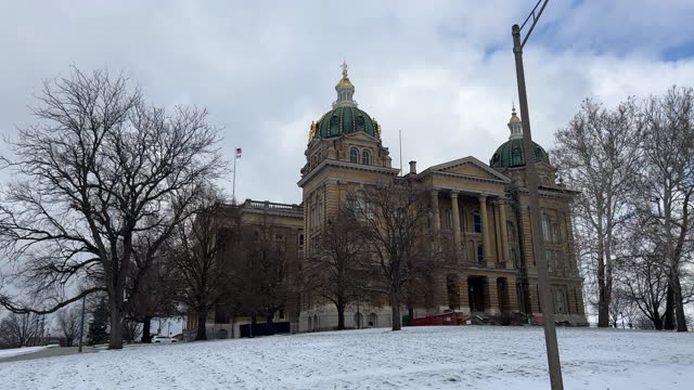 Side Trucking Shot of Driving Past the Iowa State Capitol in Des Moines on a Snowy Day