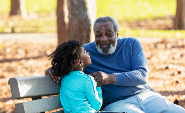 istock African-American boy, grandfather, playing on park bench 1491093642