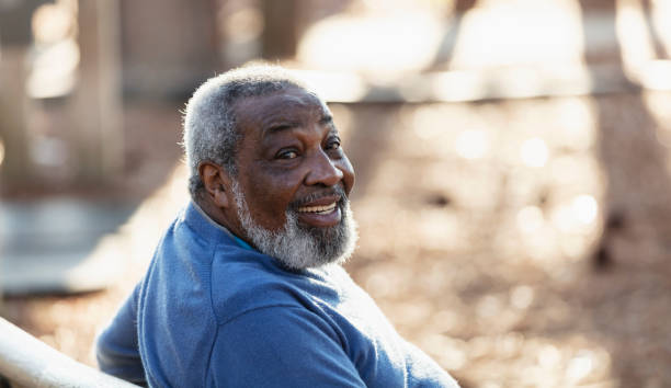 istock Senior African-American man sitting on park bench 1491093655