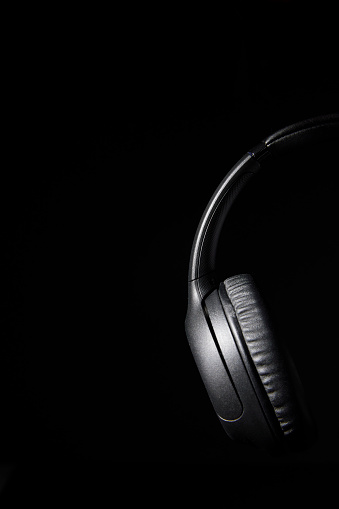 Still life photo of headphones shot in low key lighting with copy space.