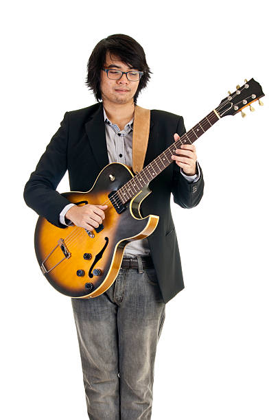 Asian young musician playing guitar isolated on white background