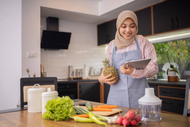 istock Joyful woman is preparing a healthy meal 1491104977