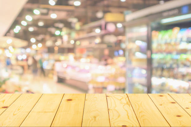 istock Empty wood table top with supermarket blurred background for product display 1491105450
