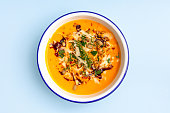 Orange creme soup with pumpkin serving with nuts and feta cheese