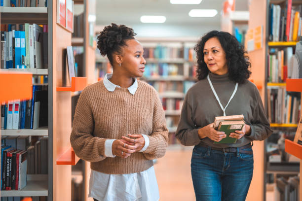 istock Hispanic Females Walking Through The Library 1491106773