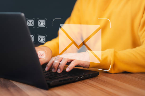 istock Concept of Email marketing, send e-mail or news letter, online working internet network. Man hand using computer laptop typing on keyboard and surfing the internet on office table with email icon. 1491106939