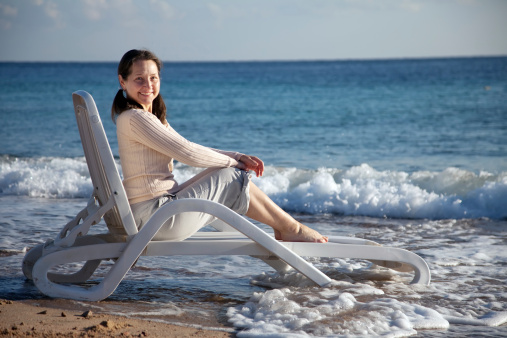 Happy mature woman enjoying  on sea beach