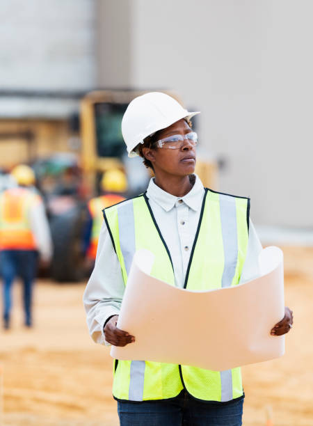 istock African-American woman with blueprints at construction site 1491120038