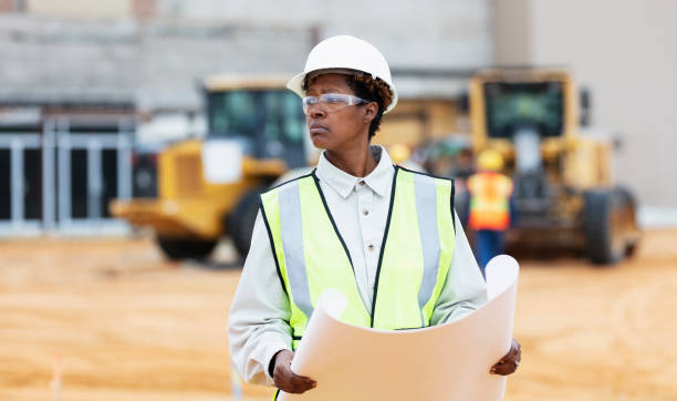 istock African-American woman with blueprints at construction site 1491120050