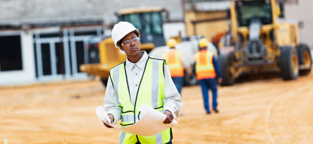 istock African-American woman with blueprints at construction site 1491120052