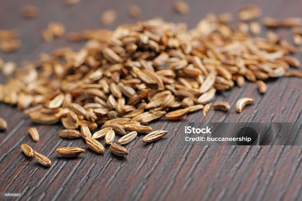 Caraway seeds Caraway seeds (Carum carvi) on dark table. Close-up photo. Brown Stock Photo