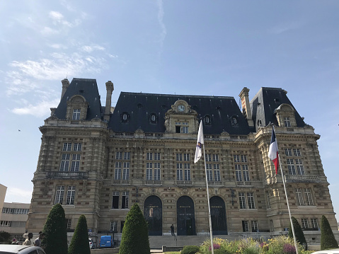 Paris, France - 07/24/2019 : one of the most enduring landmarks in a city, Hôtel de Ville (City Hall) against blue sky during summer day