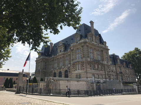 Paris, France - 07/24/2019 : one of the most enduring landmarks in a city, Hôtel de Ville (City Hall) against blue sky during summer day