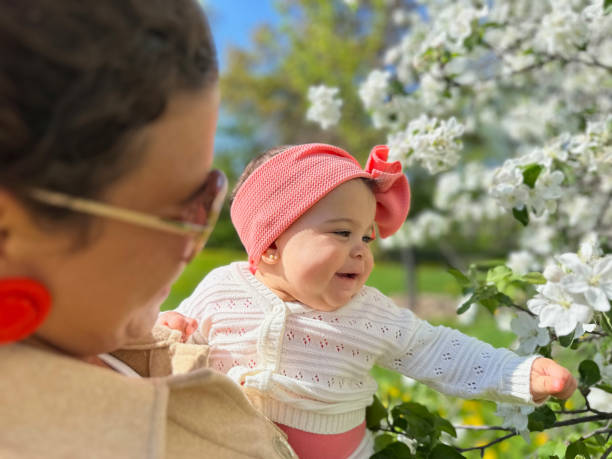 istock Mother and daughter among flowers 1491127612