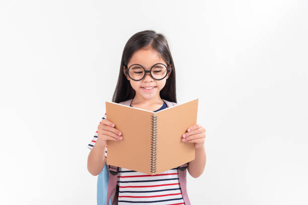 istock schoolgirl hugging book wearing backpack smiling isolated on white background 1491127631