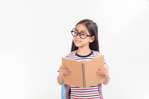 istock schoolgirl hugging book wearing backpack smiling isolated on white background 1491127632