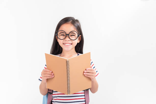 istock schoolgirl hugging book wearing backpack smiling isolated on white background 1491127641