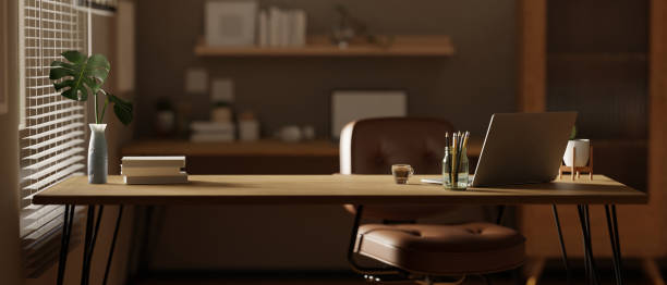 istock Front view of a workspace with laptop and copy space on a wooden tabletop 1491129754