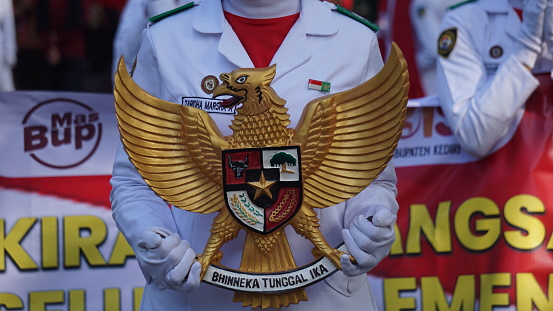 Kediri, East Java, Indonesia - May 12th, 2023 : Senior high school student holding national symbol