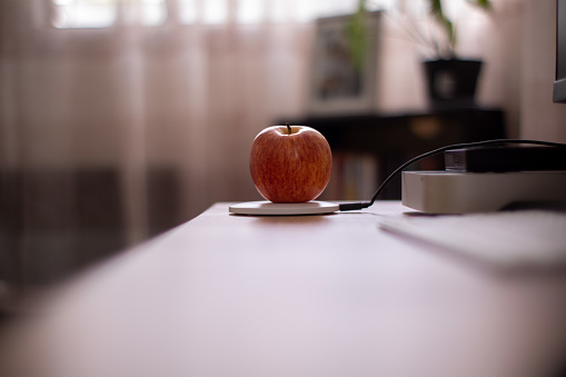 An apple fruit being charged