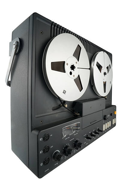 Reel-to-reel Vintage reel-to-reel tape. Isolated on white. Clipping path included. reel to reel tape stock pictures, royalty-free photos & images