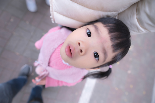 Cute little asian girl, kid portrait photo, play happily in the park