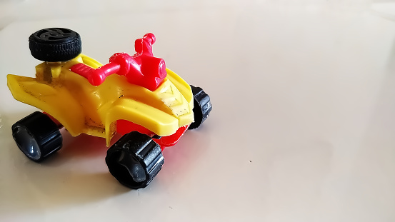 Children's toy cars with a tiled floor in the background