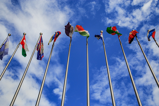 Asean Economic Community flags on the blue sky background. 3D illustration