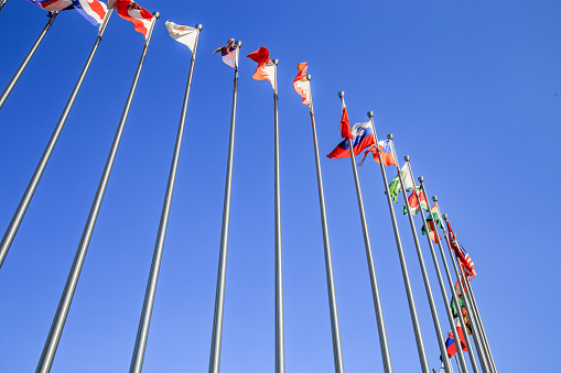 Waving flags in blue sky